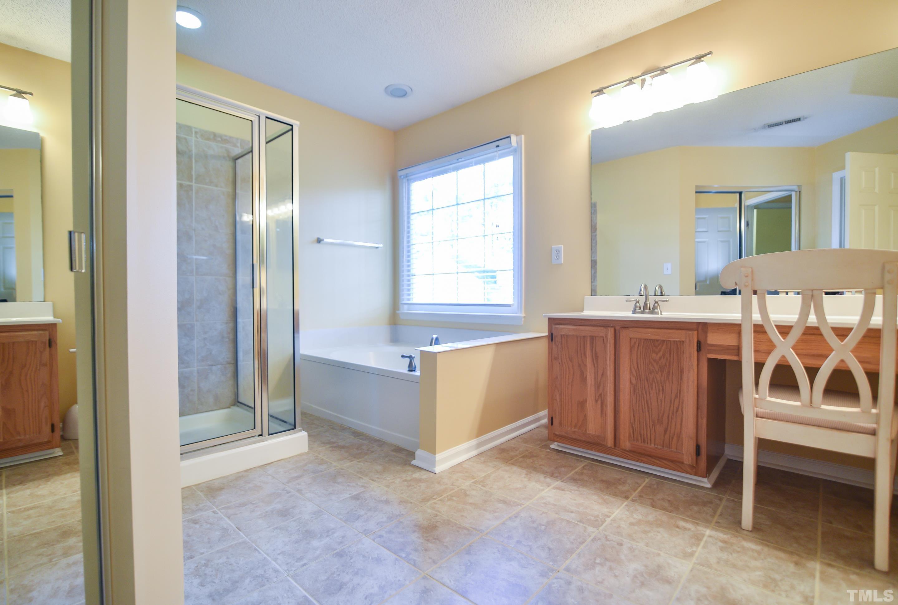 9320 Carisbrook Court Raleigh, NC 27615 - Photo 13 of 18 Convenient hall bath offers vanity and tub/shower combo!