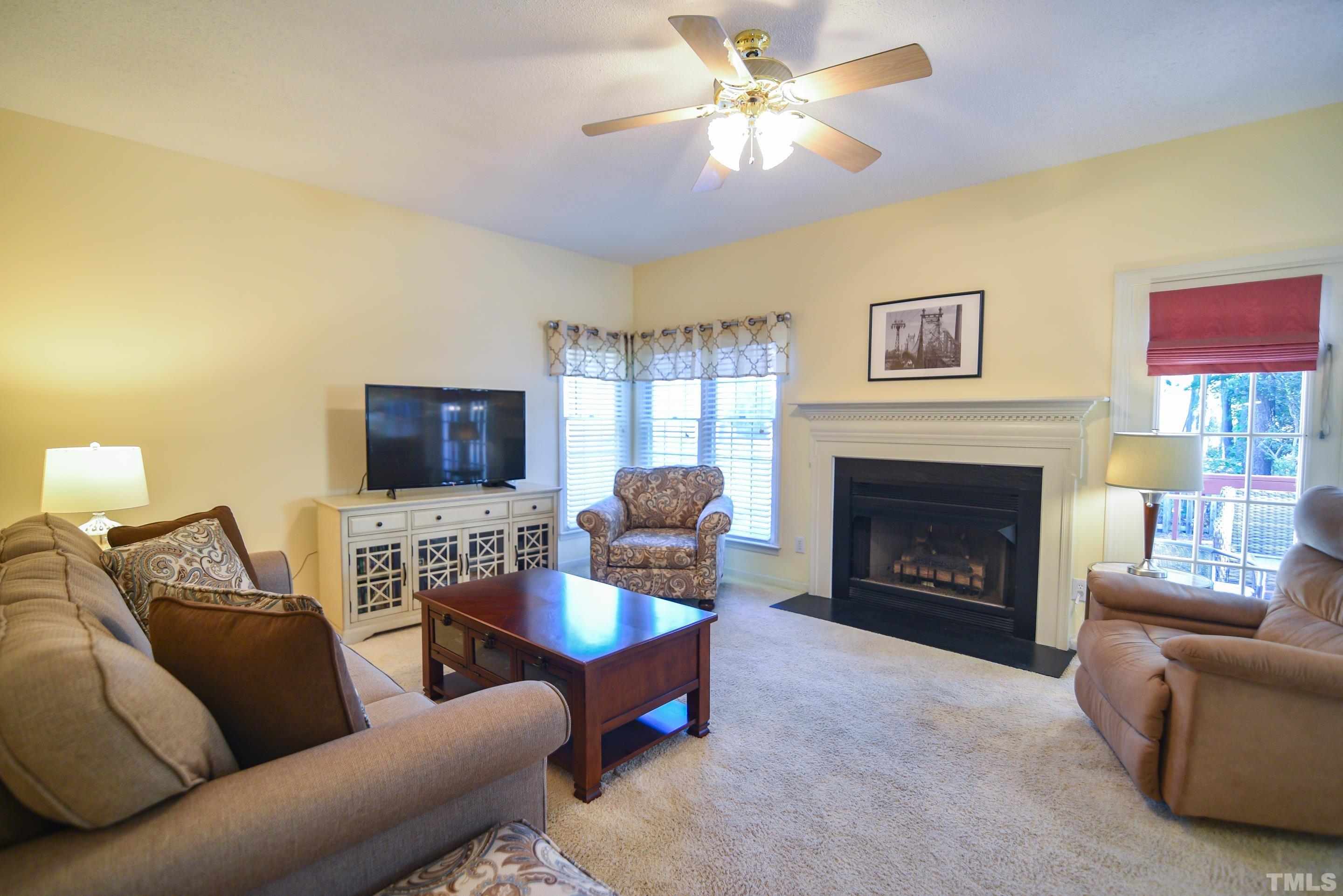 9320 Carisbrook Court Raleigh, NC 27615 - Photo 5 of 18 Timeless dining room features plush carpeting, large window, and chandelier!