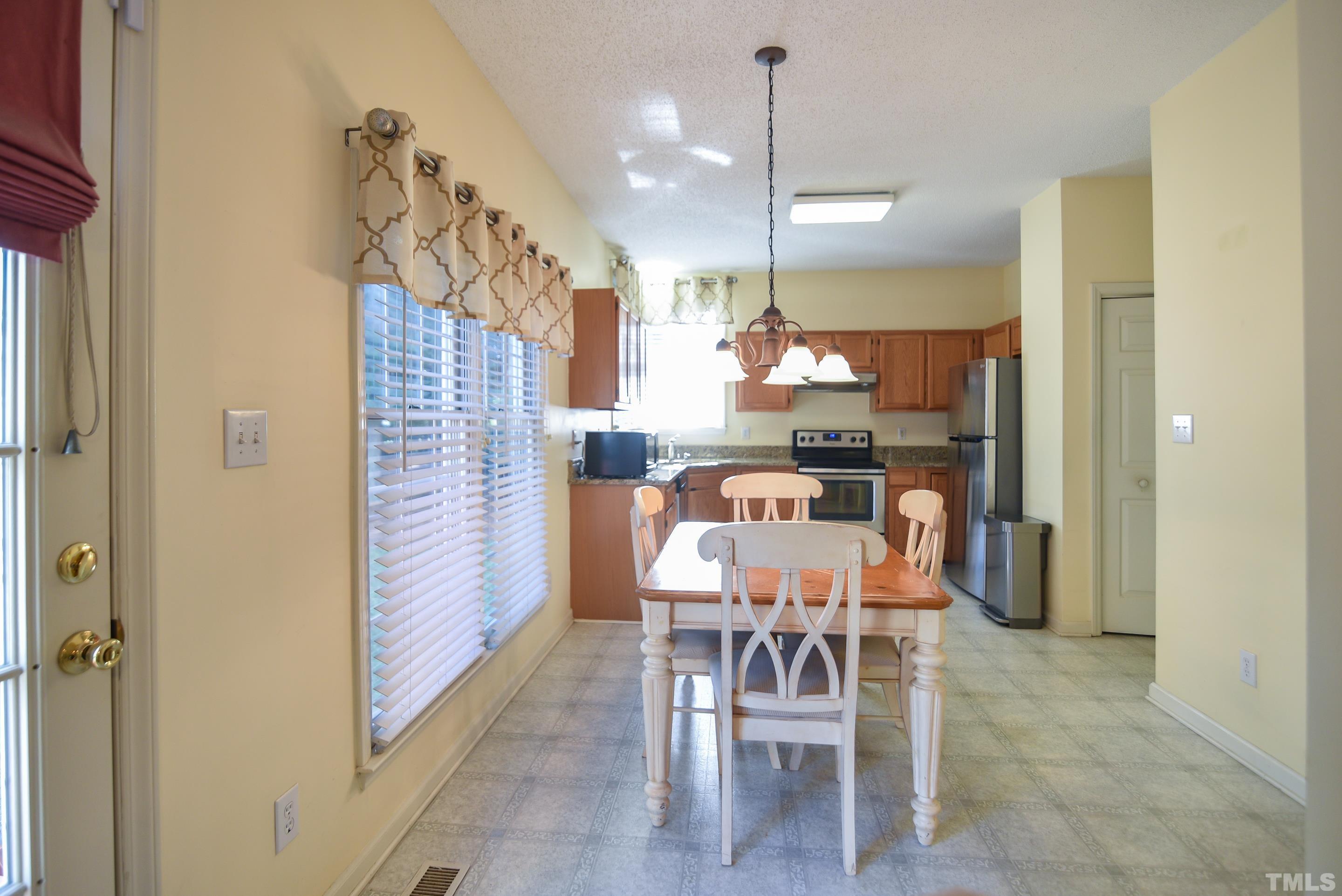 9320 Carisbrook Court Raleigh, NC 27615 - Photo 7 of 18 Enjoy casual meals or your morning coffee while taking in the view!