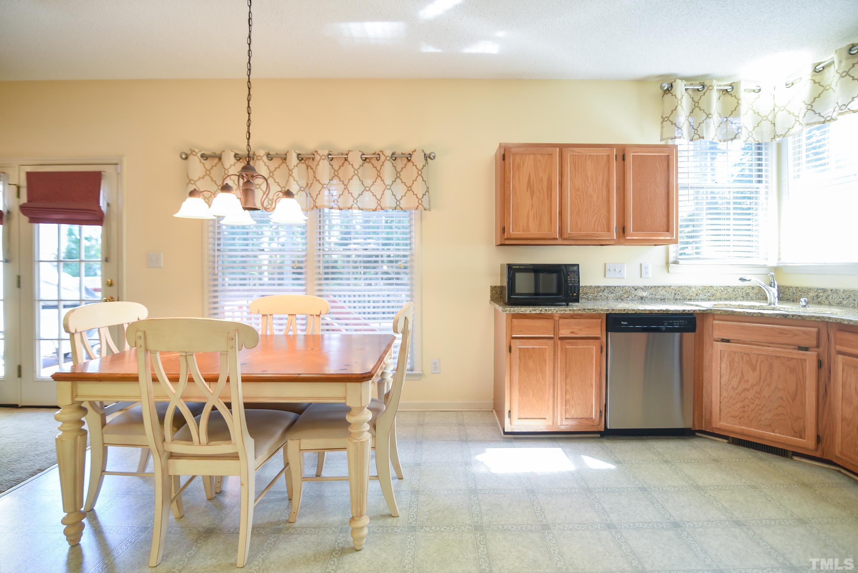 9320 Carisbrook Court Raleigh, NC 27615 - Photo 8 of 18 A welcome place to gather, large family room features large windows offering plenty of natural light, neutral palette, and charming fireplace perfect for chilly evenings!