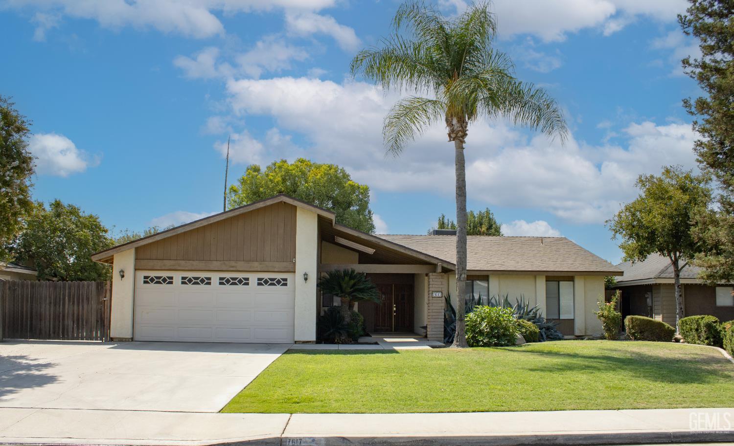 Undisclosed Address Bakersfield, CA 93309 - Photo 1 of 38 a front view of a house with a garden and tree