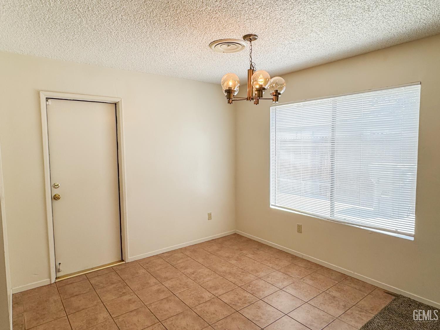 Undisclosed Address Bakersfield, CA 93309 - Photo 11 of 38 a view of a livingroom with a chandelier