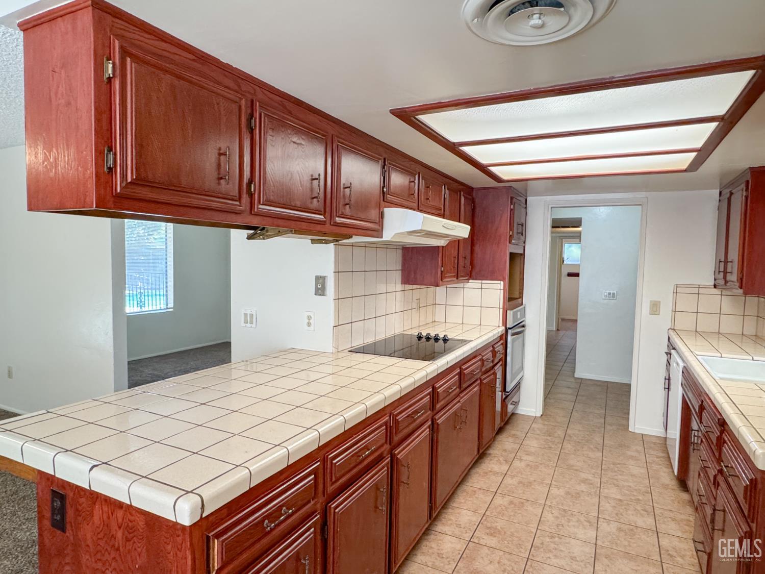 Undisclosed Address Bakersfield, CA 93309 - Photo 14 of 38 a kitchen that has a sink and a stove top oven