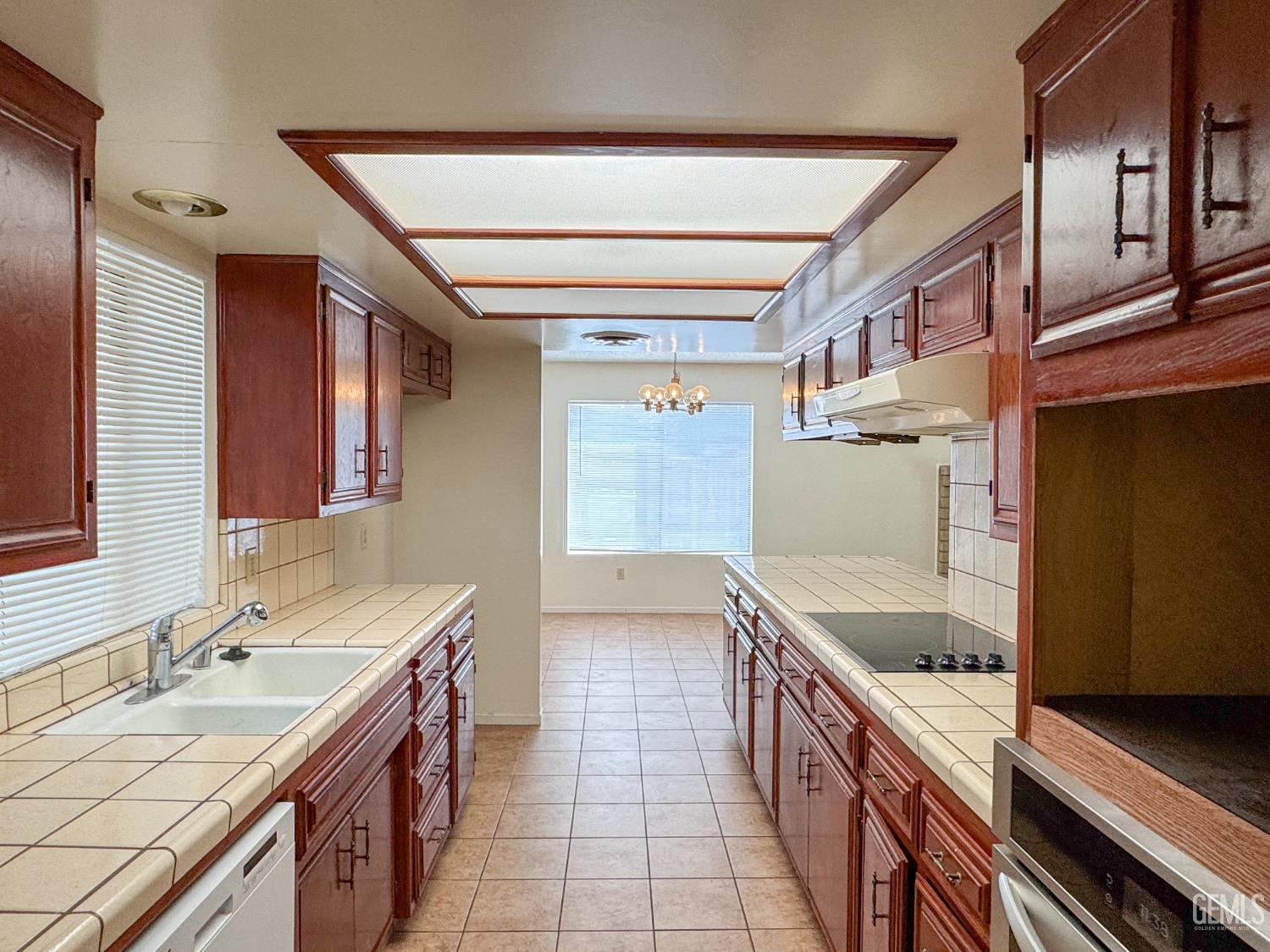 Undisclosed Address Bakersfield, CA 93309 - Photo 15 of 38 a kitchen with a sink stove and cabinets