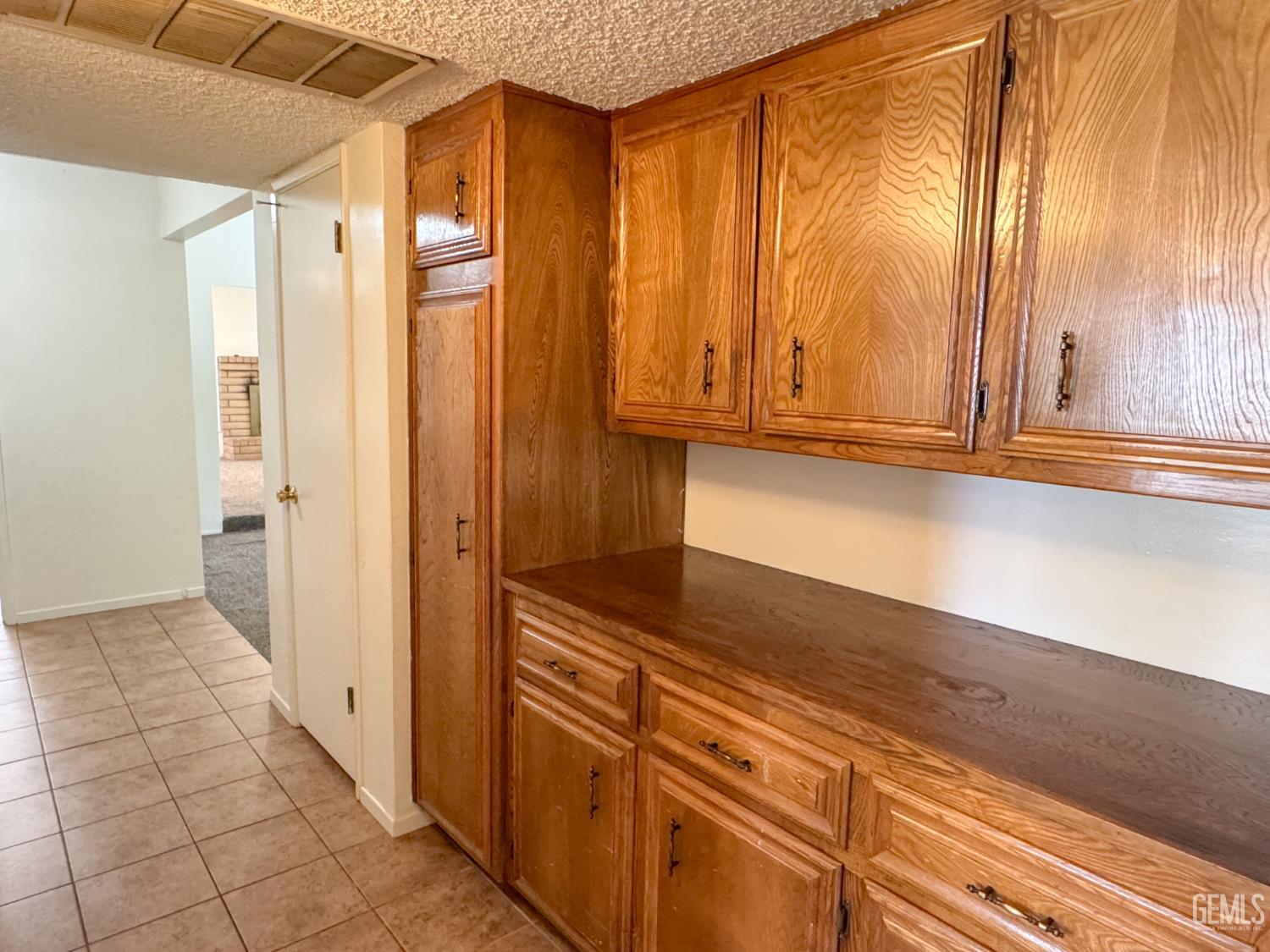 Undisclosed Address Bakersfield, CA 93309 - Photo 16 of 38 a view of a kitchen with wooden floor and cabinets