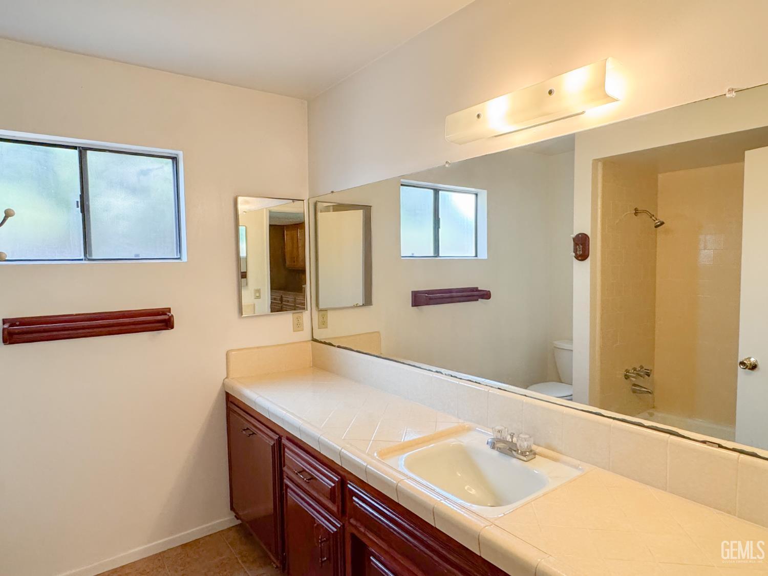 Undisclosed Address Bakersfield, CA 93309 - Photo 21 of 38 a bathroom with a sink and a mirror