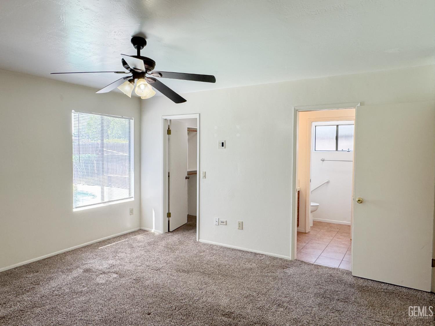 Undisclosed Address Bakersfield, CA 93309 - Photo 23 of 38 a view of empty room with windows and ceiling fan