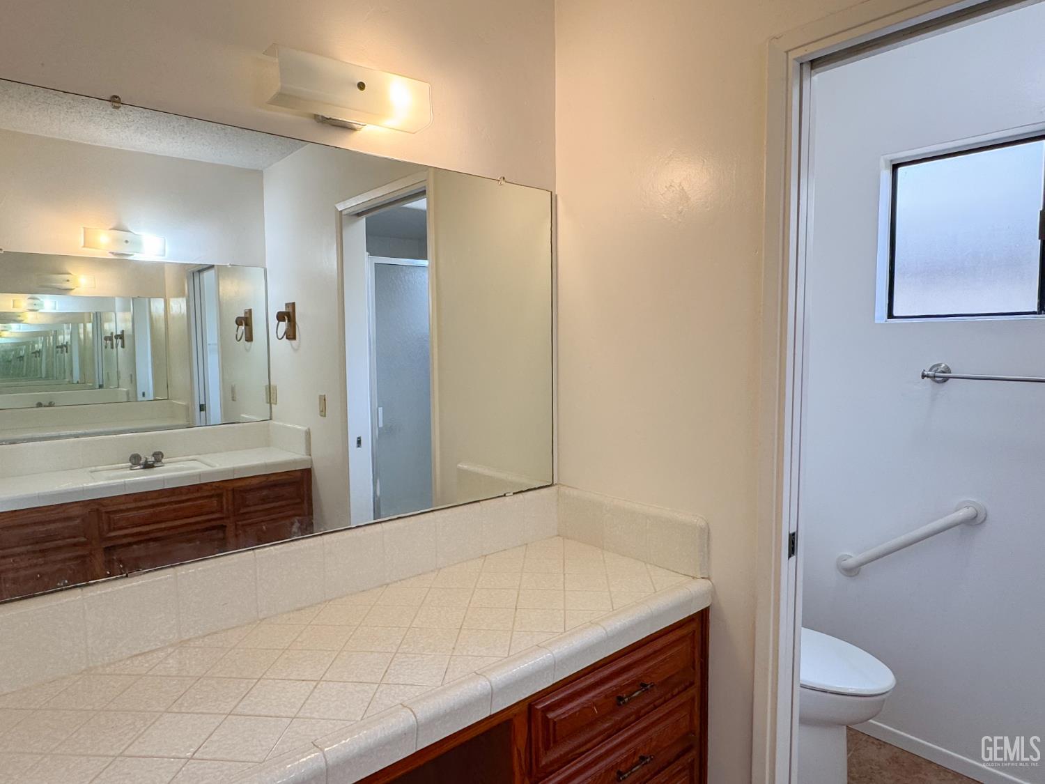 Undisclosed Address Bakersfield, CA 93309 - Photo 27 of 38 a bathroom with a sink a toilet and shower