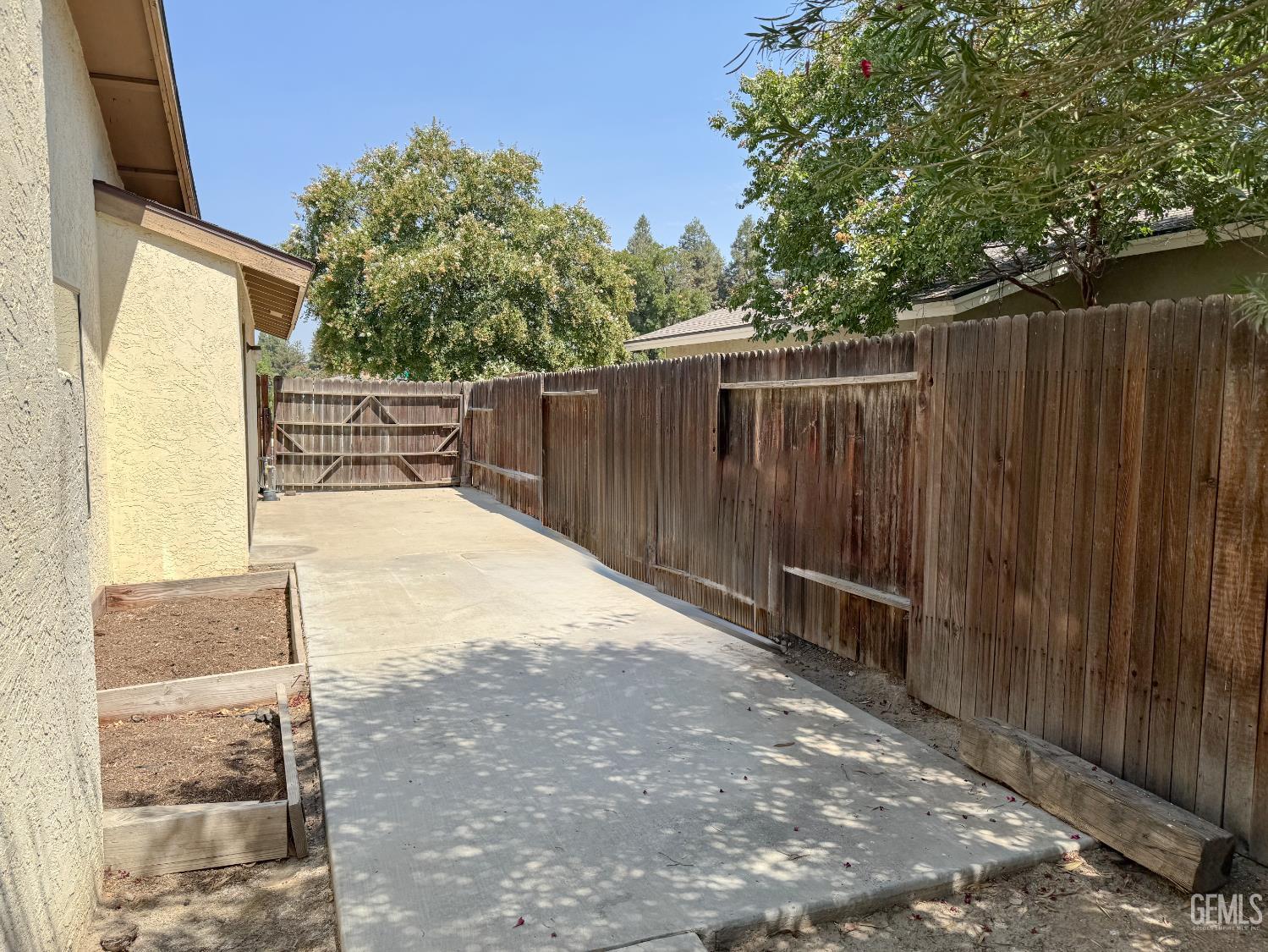 Undisclosed Address Bakersfield, CA 93309 - Photo 28 of 38 a view of backyard with wooden fence and trees