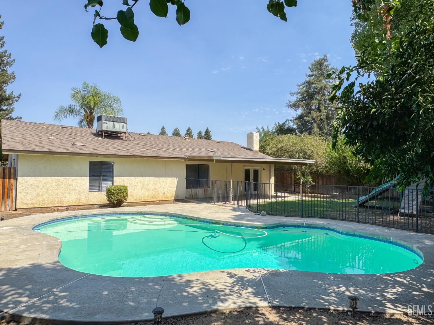 Undisclosed Address Bakersfield, CA 93309 - Photo 34 of 38 a front view of a house with garden and patio