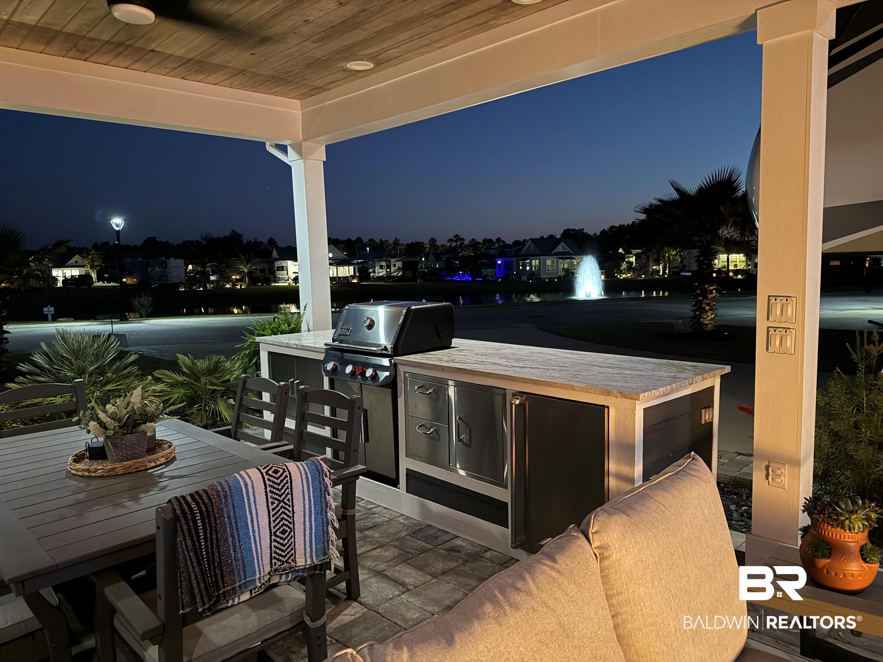 12377 Gateway Drive Elberta, AL 36530 - Photo 30 of 64 Patio at twilight with an outdoor kitchen / dining area and a patio