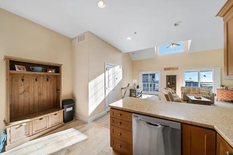 a kitchen with granite countertop a sink and a refrigerator