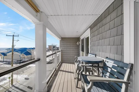 a view of a balcony dining area with furniture
