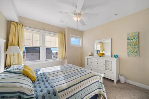 a bedroom with a bed dresser and a window