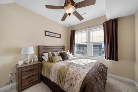 a bed sitting in a bedroom next to a window