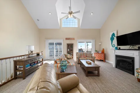 a living room with furniture fireplace and flat screen tv