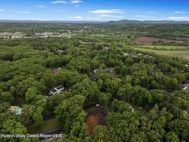 an aerial view of residential houses with outdoor and green space