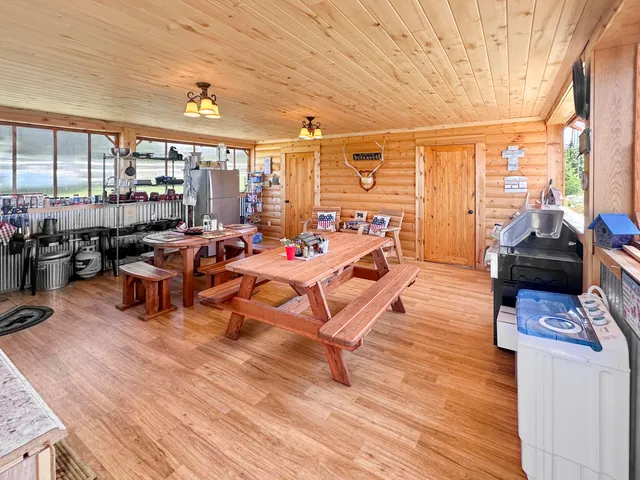a living room with patio furniture and a wooden floor
