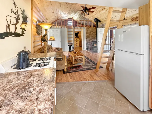 a view of a living room with furniture and a floor to ceiling window