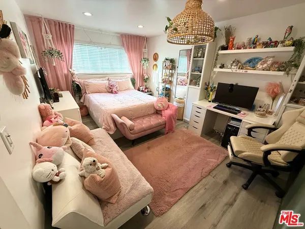 a bedroom with furniture and a flat screen tv