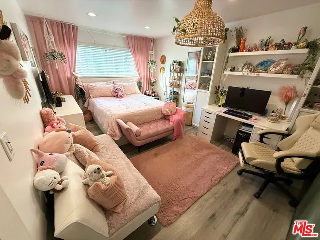 a bedroom with furniture and a flat screen tv