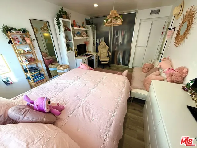 a bed room with a bed and a mirror