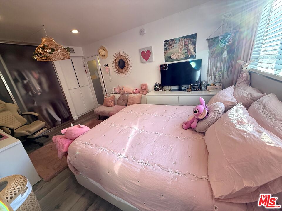 843 4th Street, Unit 207 Santa Monica, CA 90403 - Photo 17 of 49 a bedroom with a bed window and flat screen tv