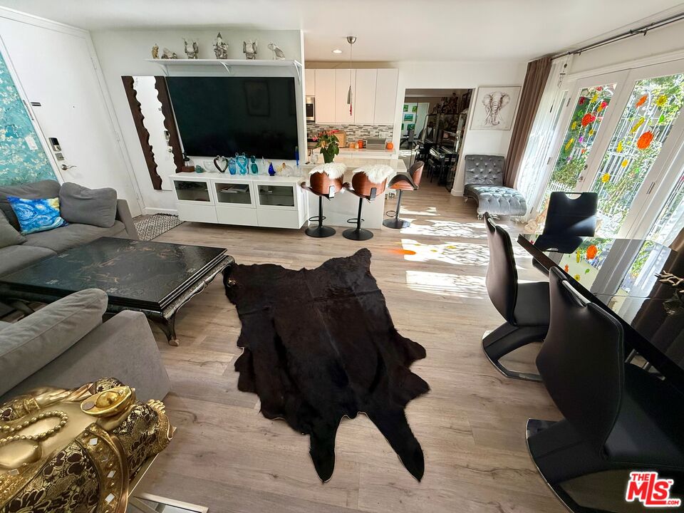 843 4th Street, Unit 207 Santa Monica, CA 90403 - Photo 2 of 49 a living room with furniture and a flat screen tv