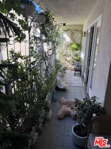 a view of a patio with chairs and table under an umbrella