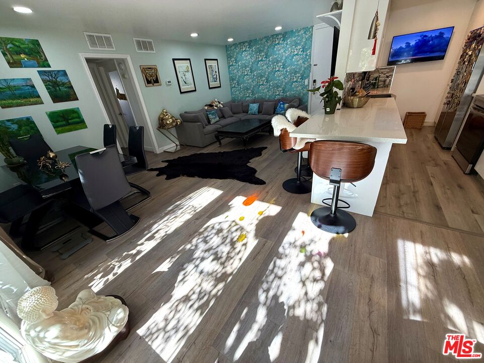 843 4th Street, Unit 207 Santa Monica, CA 90403 - Photo 3 of 49 a living room with furniture and a fireplace