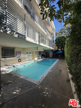 a bathroom with a granite countertop toilet sink and mirror