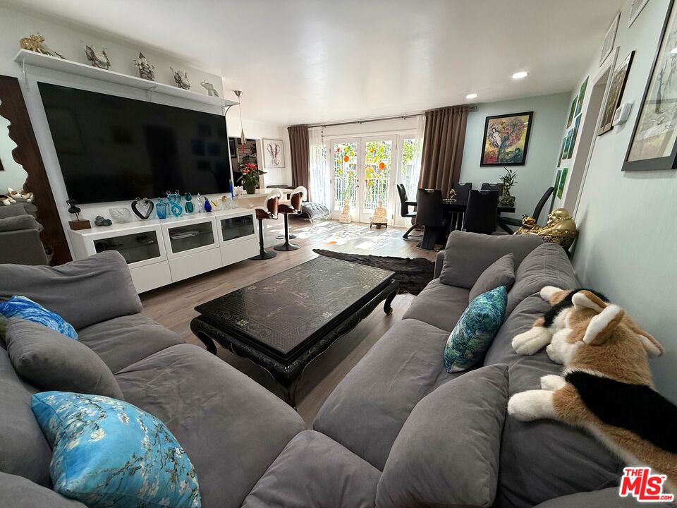 843 4th Street, Unit 207 Santa Monica, CA 90403 - Photo 4 of 49 a living room with furniture and a flat screen tv