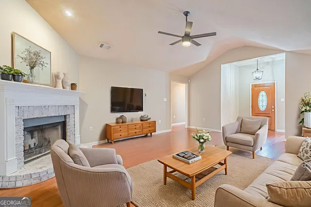 a view of a livingroom with a window and a fireplace