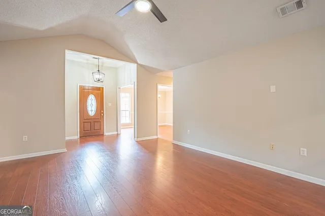 a large kitchen with a sink and cabinets