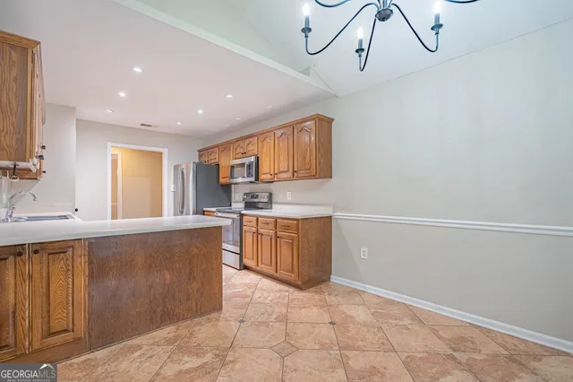 a kitchen with a sink stove and cabinets