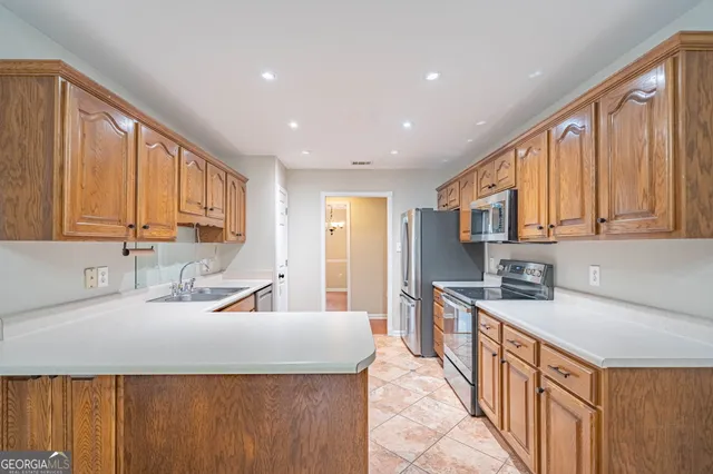 a kitchen with stainless steel appliances granite countertop a sink stove and cabinets
