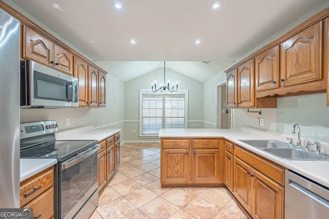 a bedroom with a large bed and a flat tv screen