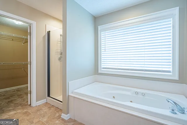 an empty room with closet and fan