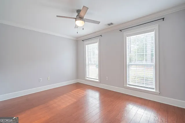 a view of an empty room with a fireplace and a window