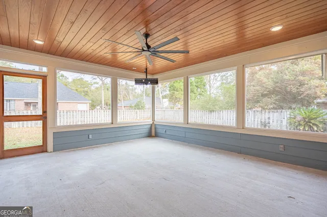 a view of house with garden space and sitting area