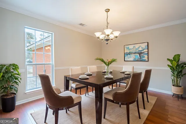 a view of a dining room with furniture window and wooden floor