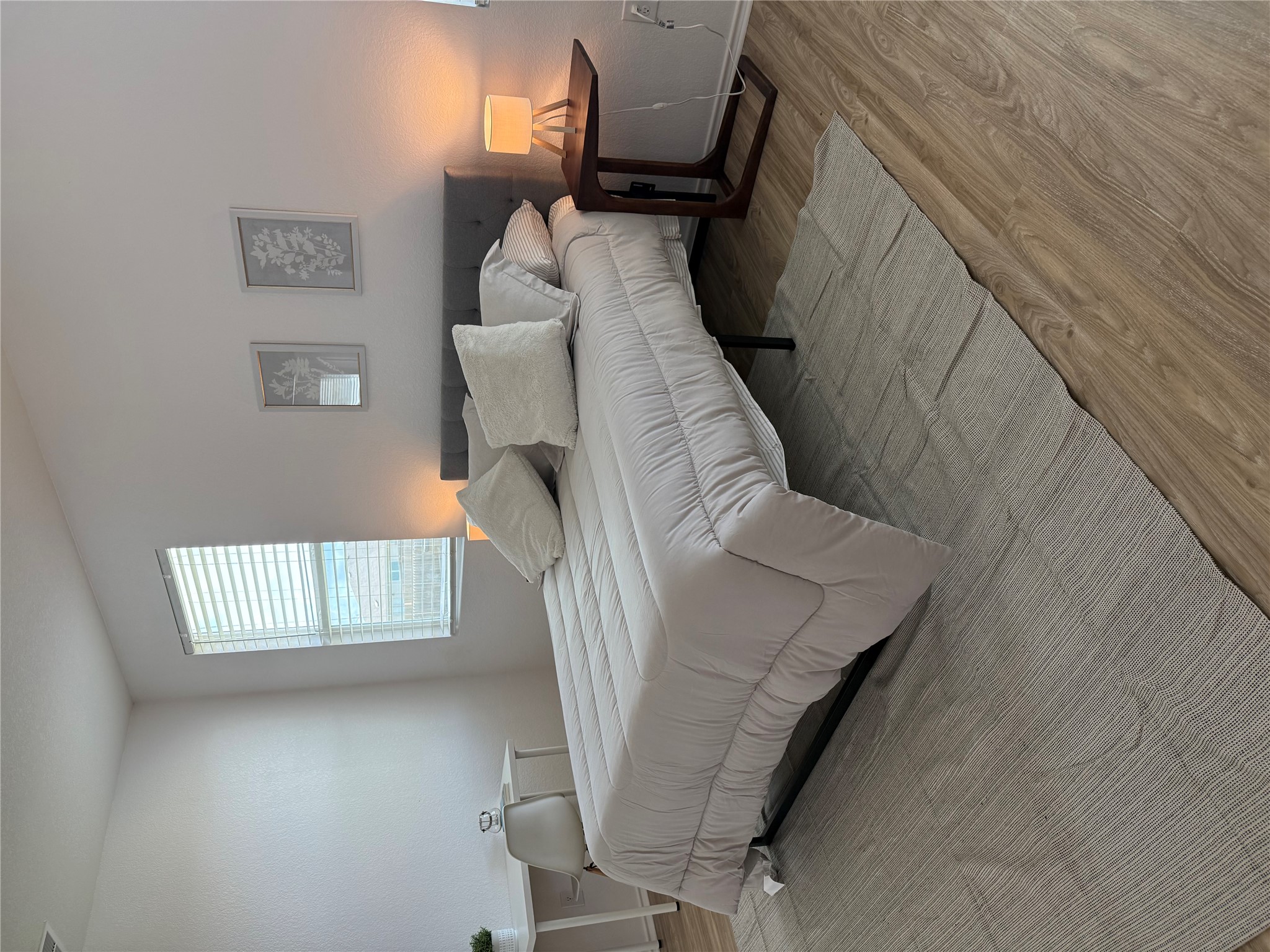 14907 Retha Pass Austin, TX 78725 - Photo 12 of 22 Well-lit sleeping quarters with rich hardwood flooring and a neutral color scheme.