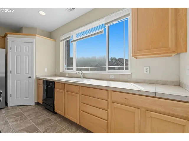 a kitchen that has a sink a stove and a table