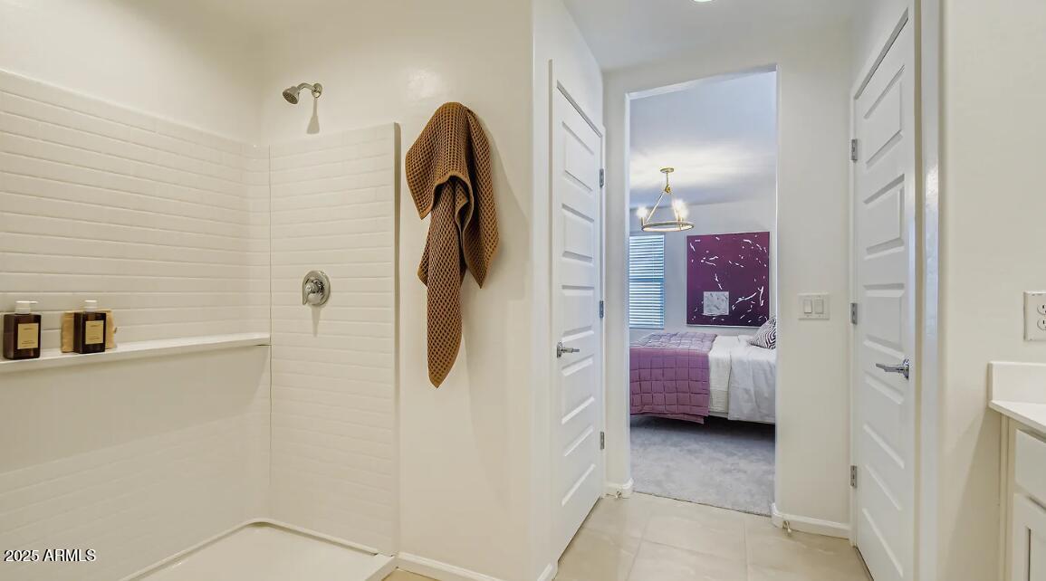 9553 West Verde Lane Phoenix, AZ 85392 - Photo 12 of 24 a bathroom with a sink and a shower