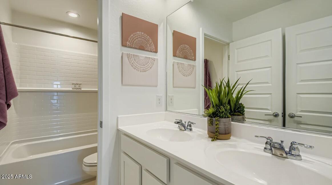 9553 West Verde Lane Phoenix, AZ 85392 - Photo 14 of 24 a bathroom with a granite countertop sink a toilet and shower