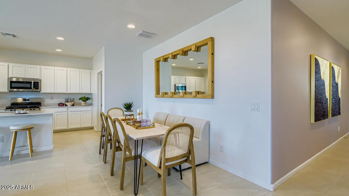 9553 West Verde Lane Phoenix, AZ 85392 - Photo 4 of 24 a view of a dining room with furniture and wooden floor