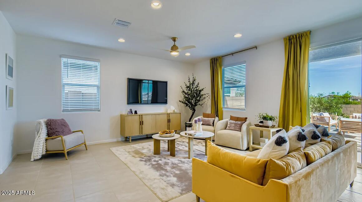 9553 West Verde Lane Phoenix, AZ 85392 - Photo 5 of 24 a living room with furniture and a flat screen tv