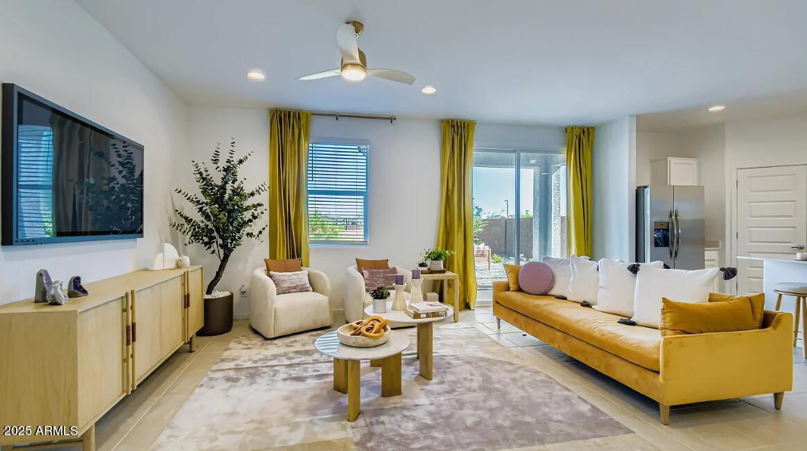 9553 West Verde Lane Phoenix, AZ 85392 - Photo 6 of 24 a living room with furniture and a flat screen tv