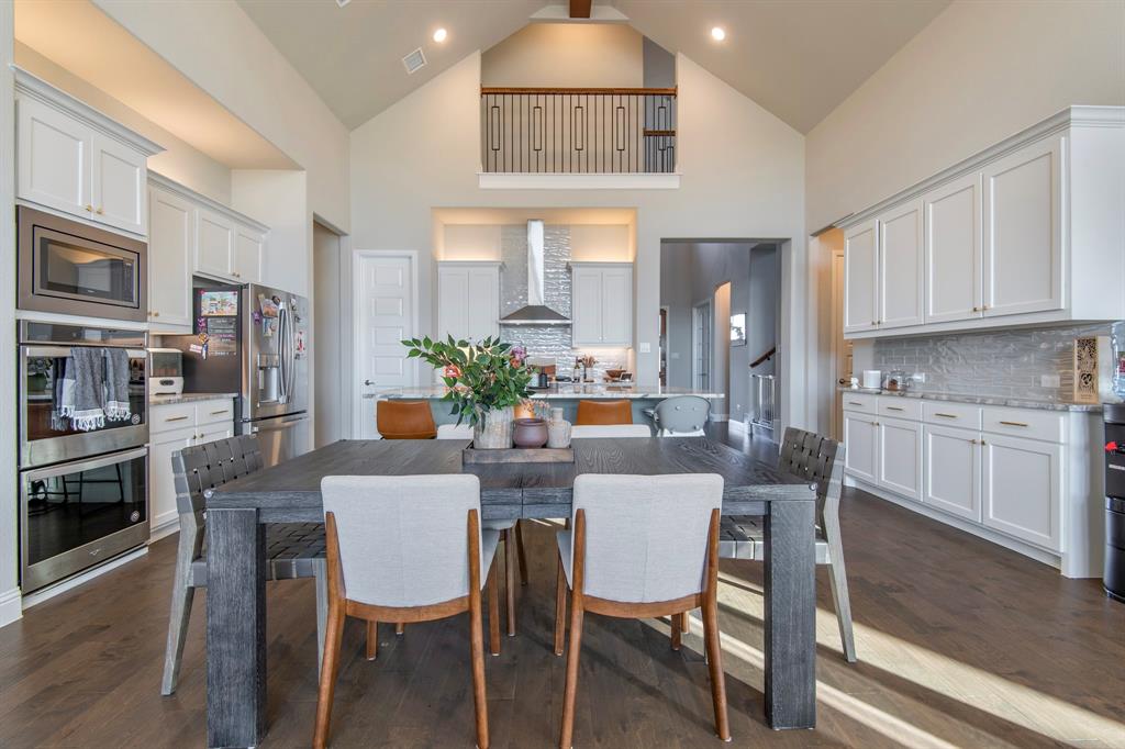 16650 Nightshade Road Frisco, TX 75033 - Photo 17 of 40 a view of a dining room with furniture window and wooden floor