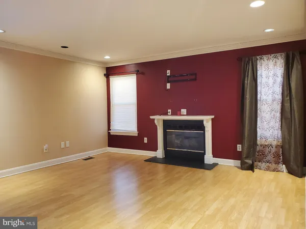 a view of an empty room with a fireplace